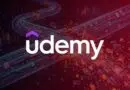 Udemy logo over a neon red and purple futuristic digital network background
