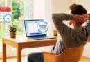 Man relaxing at a wooden desk with a laptop showing a Windows Update notification; a calendar and clock icon float nearby.