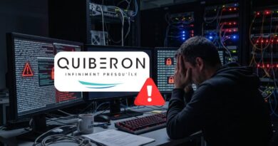 Man sits at a cluttered desk in a server room, hands on face as monitors show code and warning icons with a Quiberon logo overlay. They appear stressed by a cybersecurity alert.