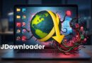Laptop open to a glowing globe with a large yellow download arrow wrapping around it, tangled in red cables, with 'JDownloader' text in the foreground on a dark desk backdrop.