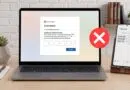 Laptop shows a fake Microsoft sign-in with a security code entry and a red X, indicating a blocked login; a phone on a stand displays a code SMS beside it.