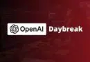 OpenAI Daybreak branding over a dark, code-filled developer workstation with monitors and keyboards.