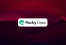 Rocky Linux logo centered on a white rounded rectangle with a green emblem, set against a dark red to purple abstract background.