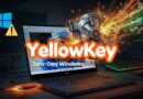 Laptop on a dark desk with fiery cyber effects and a vault exploding, overlaid with 'YellowKey Zero-Day Windows' text indicating a Windows exploit concept