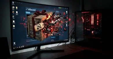 Gaming setup with a curved monitor showing a Steam Workshop splash and a crate exploding on screen, plus a red-lit PC tower to the right