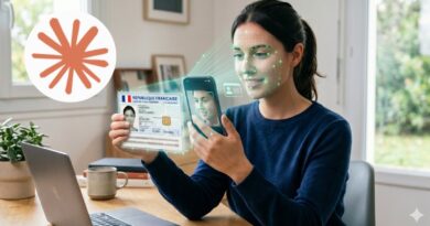 Woman at a desk holds a French identity card and scans it with her phone, with a facial recognition overlay on her face.