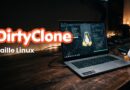Promotional banner for DirtyClone Faille Linux: laptop with code on screen and penguin figurines on a wooden desk.