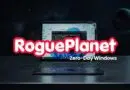 RoguePlanet branding across a cracked laptop screen on a starry space background with the caption 'Zero-Day Windows'