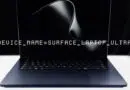 Laptop with a display showing 'DEVICE_NAME=SURFACE_LAPTOP_ULTRA' on a dark screen.