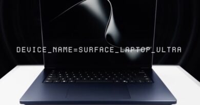 Laptop with a display showing 'DEVICE_NAME=SURFACE_LAPTOP_ULTRA' on a dark screen.