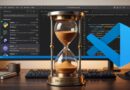 Hourglass on a desk in front of a monitor displaying VS Code and code, symbolizing a 2-hour delay