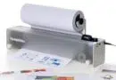 Openprinter desktop printer with a roll of paper feeding through, printing sheets in front of it