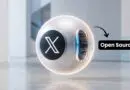 Futuristic white sphere with an X logo and glowing inner panel; an 'Open Source' label points at it.