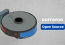 Illustrated robot vacuum cleaner with gray top and blue side panels, next to the brand name 'oomwoo' and a blue 'Open Source' button.