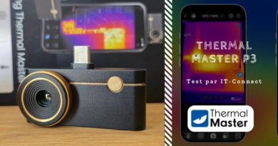 Close-up of a black dash cam with gold accents on a wooden surface; lens in view and USB-C port on top (left panel).